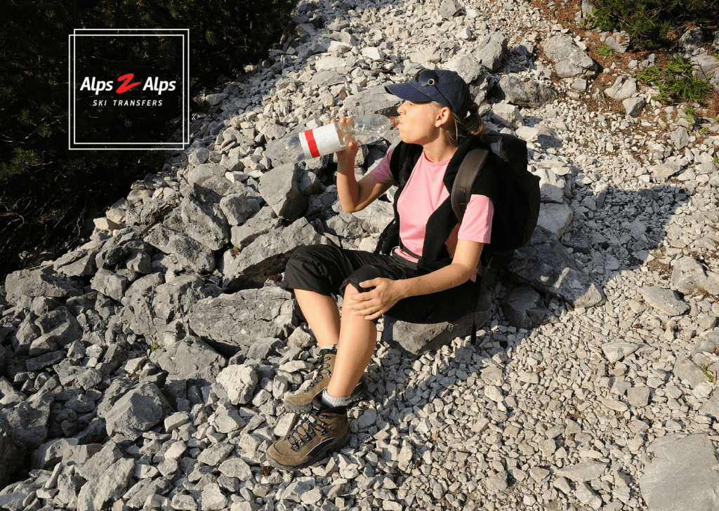 Hydrating on a summer hike in the Alps
