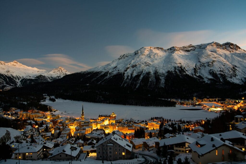 Houses in Engadin, St Moritz, lit up at night time