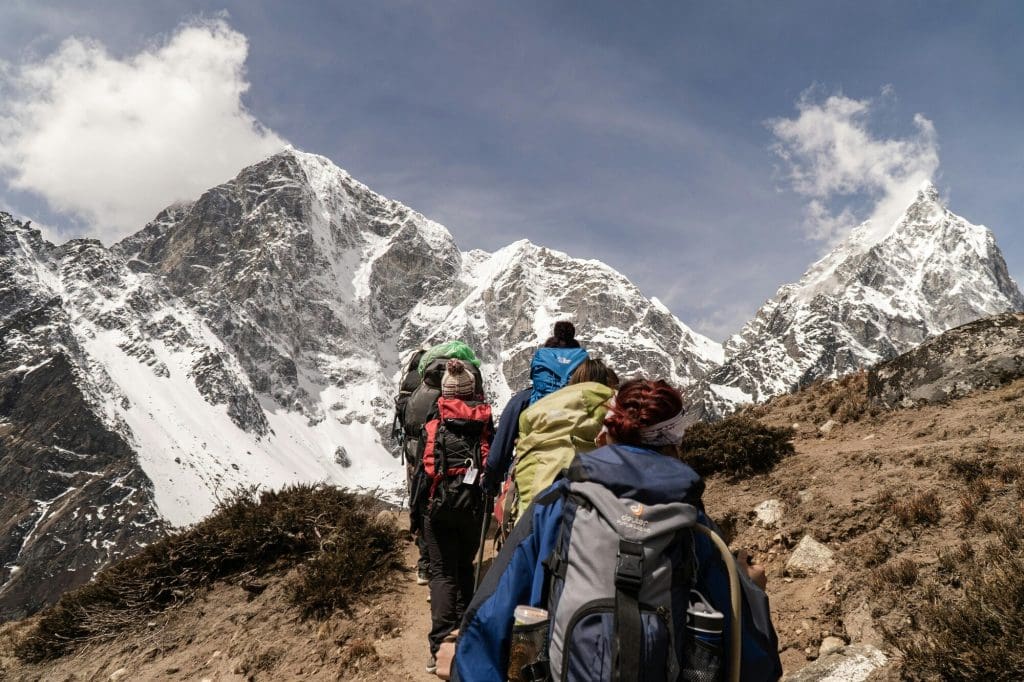 A group of people mountain climbing in the Alps